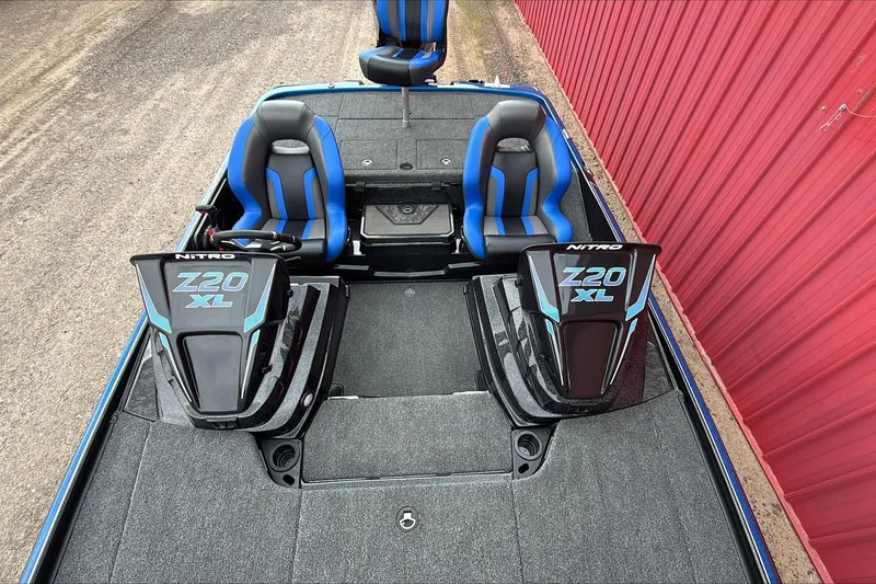 Slide: The Image of 2026 Nitro Z20 XL Pro boat with dual seats and sleek design by red wall. - 3