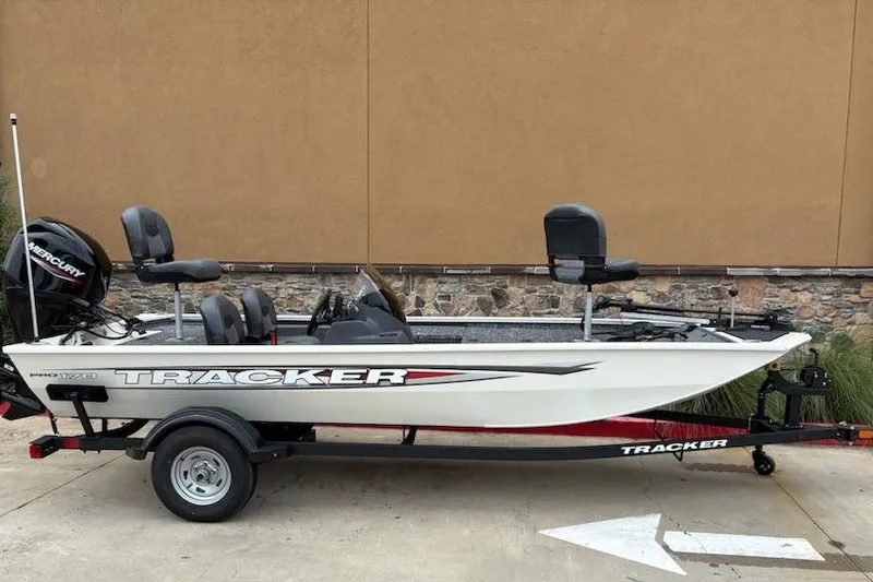 Slide: The Image of 2026 Tracker Pro 170 boat on trailer, side view, parked outdoors. - 3