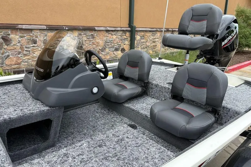 Slide: The Image of 2026 Tracker Pro 170 boat interior with gray seats and steering console. - 5