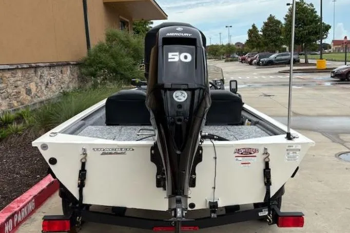 Slide: The Image of 2026 Tracker Pro 170 boat with Mercury 50 engine, parked outdoors. - 7
