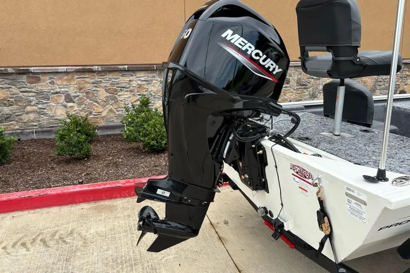 Slide: The Image of 2026 Tracker Pro 170 boat with Mercury outboard motor, parked on concrete. - 8