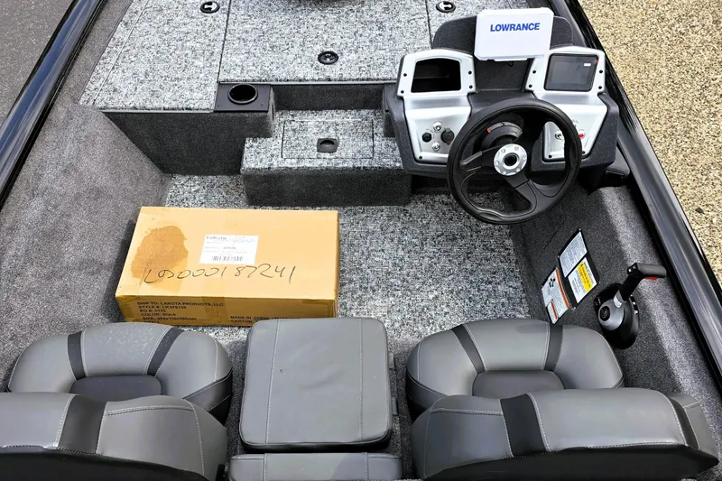 Slide: The Image of 2026 Tracker Pro Team 175 boat interior with steering wheel, seats, and Lowrance electronics. - 3