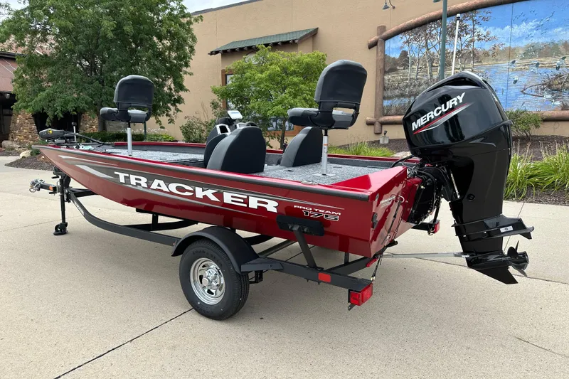 Slide: The Image of 2026 Tracker Pro Team 175 boat with Mercury engine, parked outdoors. - 2