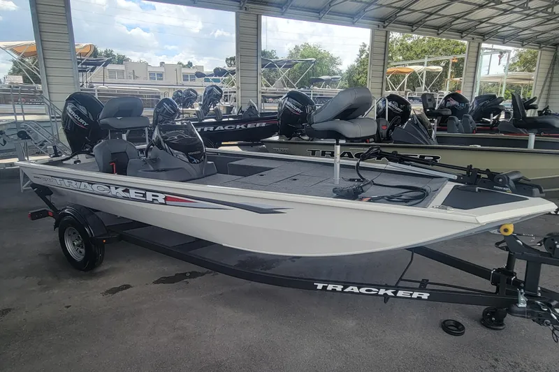 The Image of 2026 Tracker Pro 170 boat displayed in a showroom with multiple engines. - 0