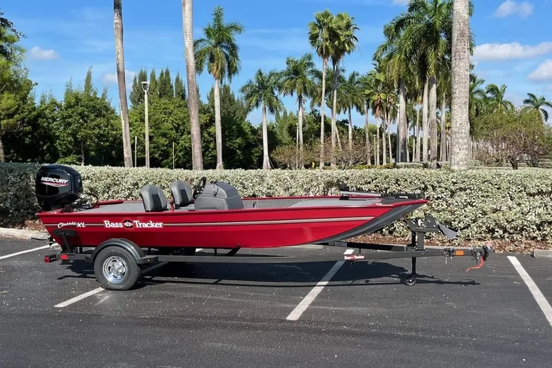 Slide: The Image of 2026 Tracker Bass Tracker Classic XL boat on trailer, parked near palm trees. - 70