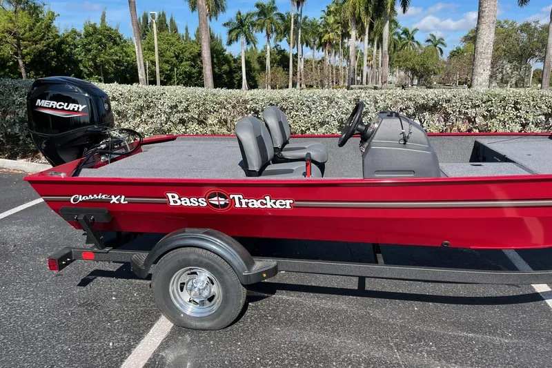 Slide: The Image of 2026 Tracker Bass Tracker Classic XL boat with Mercury engine in a parking lot. - 71