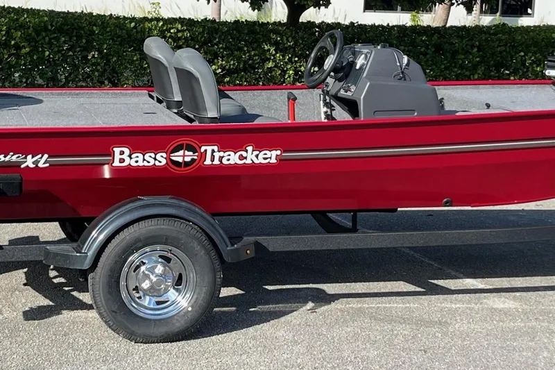 Slide: The Image of 2026 Tracker Bass Tracker Classic XL boat interior with carpeted deck and storage compartment. - 9