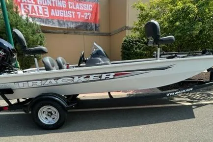 The Image of 2026 Tracker Pro 170 boat on trailer, displayed outdoors near sale banner. - 0