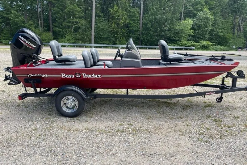 The Image of 2026 Tracker Bass Tracker Classic XL boat on trailer, red with Mercury outboard motor. - 0