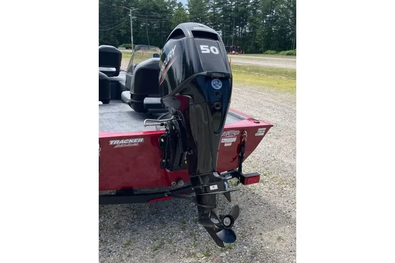 Slide: The Image of 2026 Tracker Bass Tracker Classic XL with Mercury 50 outboard motor, parked on gravel. - 6