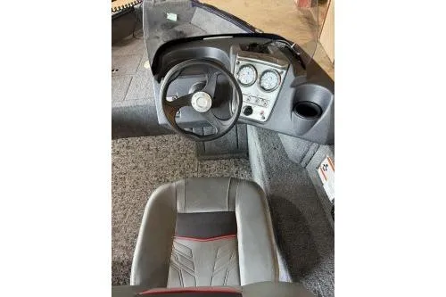 Slide: The Image of 2026 Tracker Pro Guide V-16 SC boat interior with steering wheel and dashboard controls. - 6
