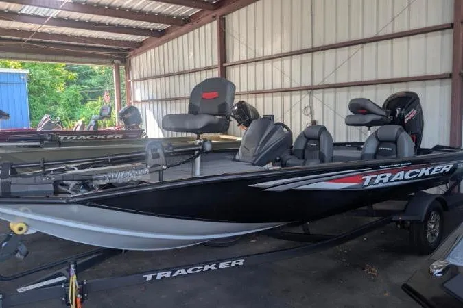 The Image of 2026 Tracker Pro Team 190 boat in a storage facility, featuring sleek black design. - 0