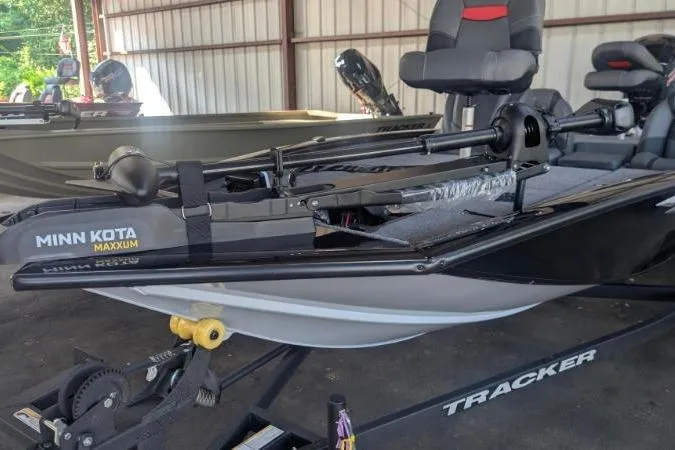 Slide: The Image of 2026 Tracker Pro Team 190 boat with Minn Kota Maxxum motor in a storage facility. - 5