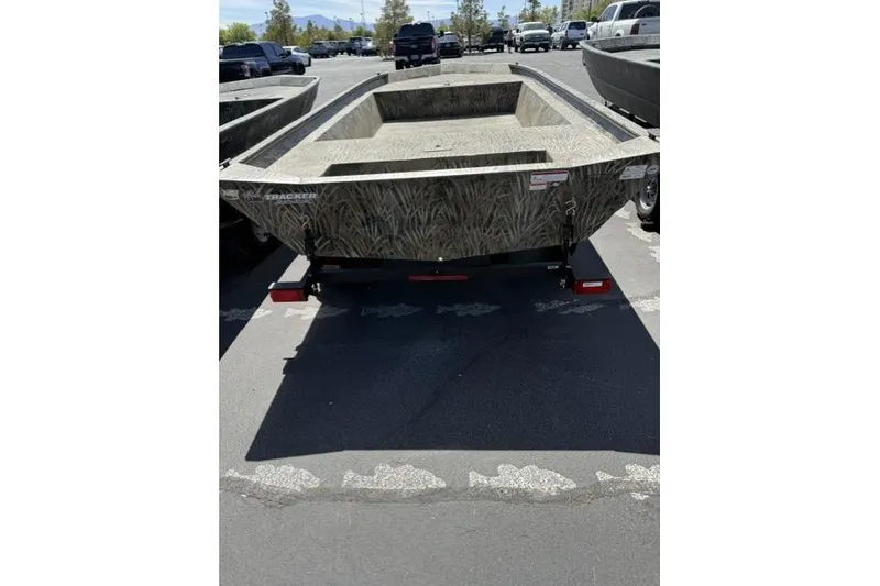 Slide: The Image of 2026 Tracker Grizzly 1860 Utility boat in parking lot, showcasing rugged design. - 3