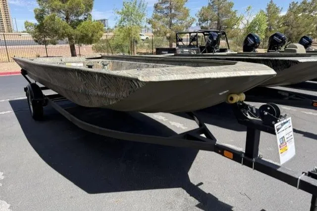 The Image of 2026 Tracker Grizzly 1860 Utility boat on trailer, parked outdoors. - 0