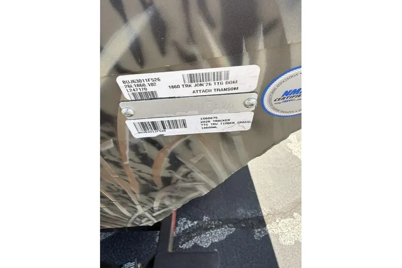Slide: The Image of 2026 Tracker Grizzly 1860 Utility boat with identification labels and certification sticker. - 8