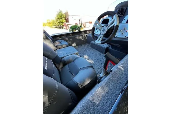 Slide: The Image of 2026 Tracker Pro Team 175 boat interior with steering wheel and seating. - 7