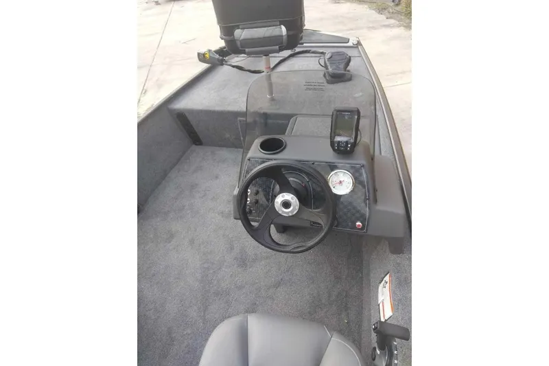 Slide: The Image of 2026 Tracker Bass Tracker Classic XL boat interior with steering wheel and navigation equipment. - 2