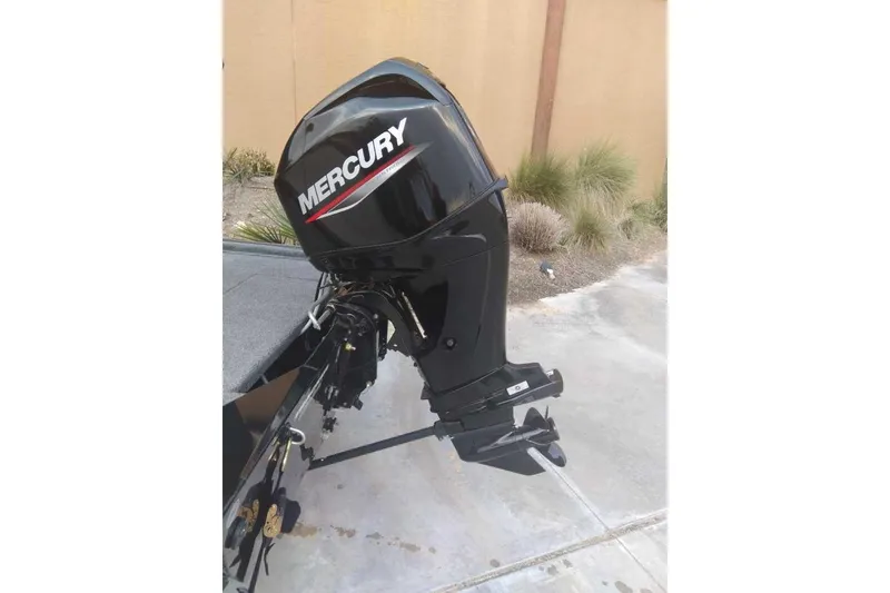 Slide: The Image of 2026 Tracker Bass Tracker Classic XL with Mercury outboard motor in driveway. - 3