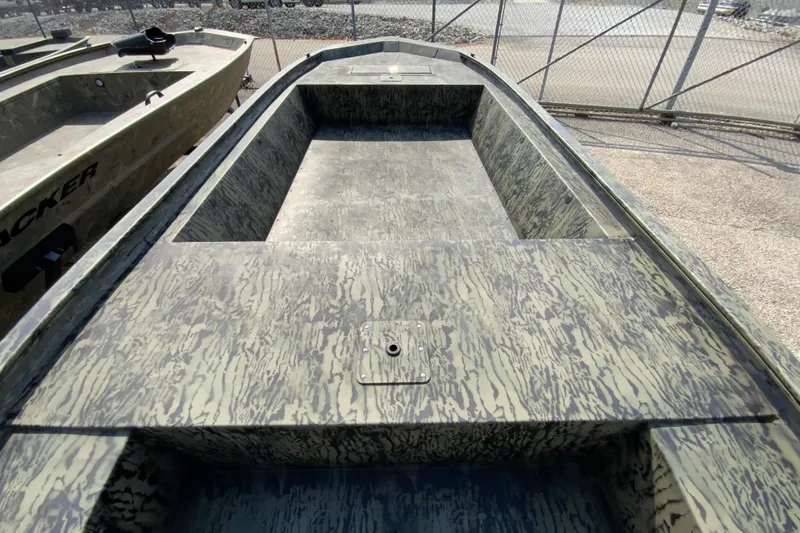 Slide: The Image of 2026 Tracker Grizzly 1648 Utility boat with camouflage pattern, parked near a chain-link fence. - 10