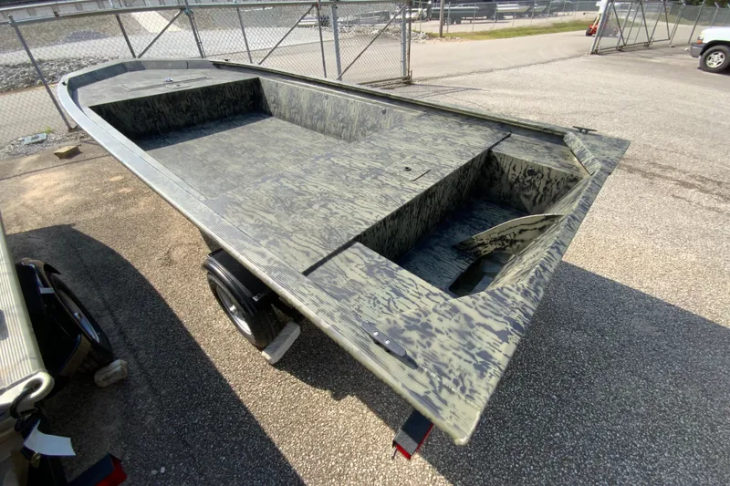 Slide: The Image of 2026 Tracker Grizzly 1648 Utility boat with camouflage design on a trailer. - 3