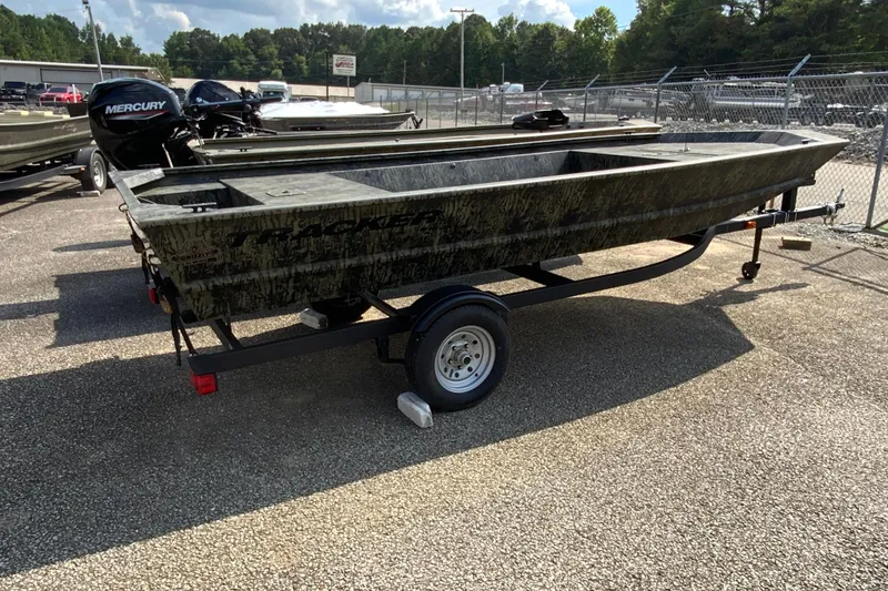 Slide: The Image of 2026 Tracker Grizzly 1648 Utility boat on trailer, parked outdoors. - 7