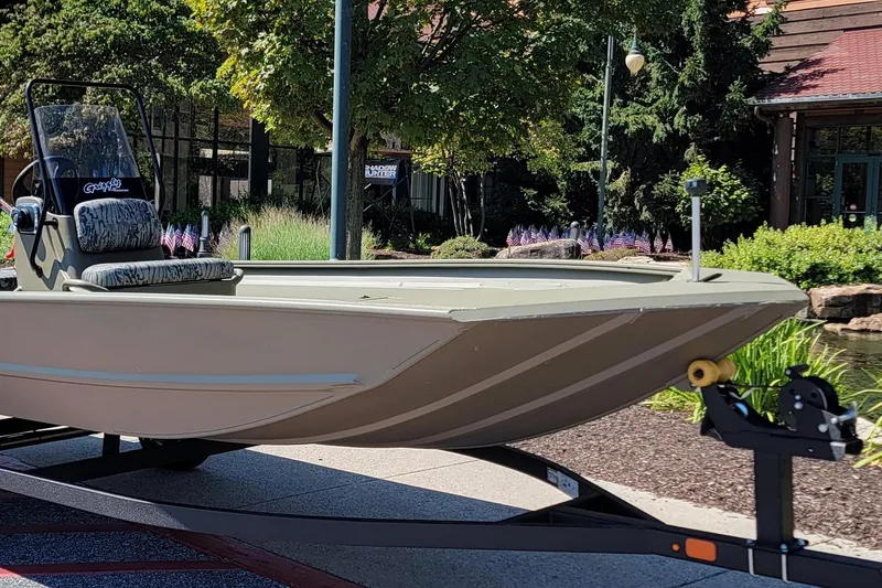 Slide: The Image of 2026 Tracker Grizzly 1860 CC boat with Mercury 80 engine, parked outdoors. - 2