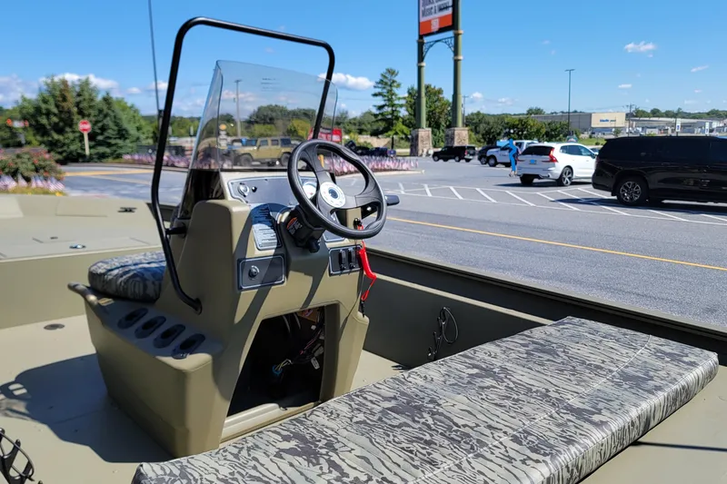 Slide: The Image of 2026 Tracker Grizzly 1860 CC boat on trailer, outdoor setting. - 3