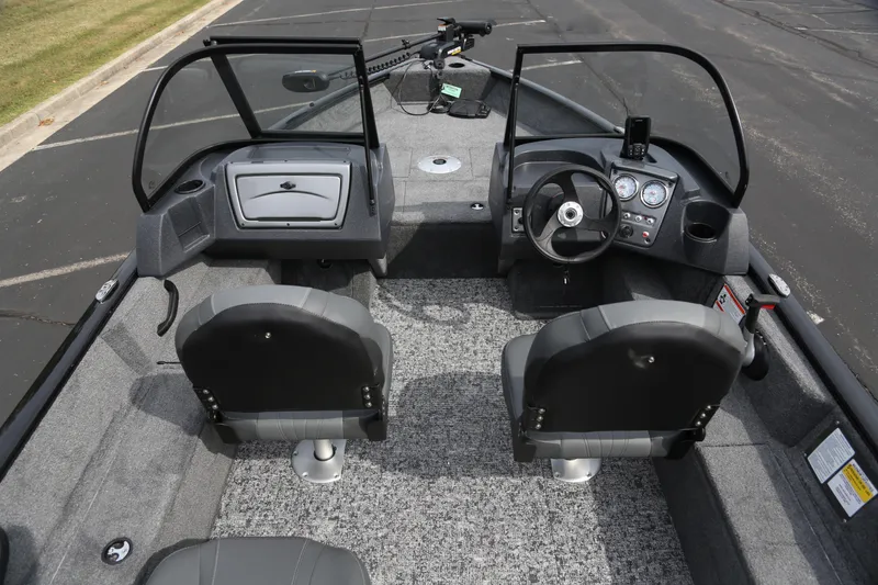 Slide: The Image of 2026 Tracker Pro Guide V-16 WT boat interior with dual seats and dashboard controls. - 3