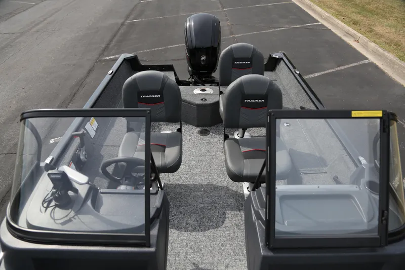 Slide: The Image of 2026 Tracker Pro Guide V-16 WT boat interior with seating and steering console. - 4