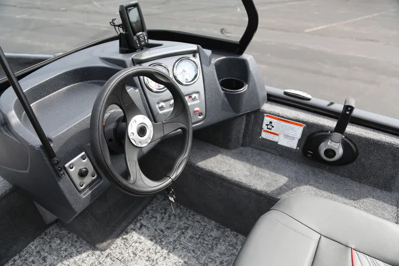 Slide: The Image of 2026 Tracker Pro Guide V-16 WT boat interior with steering wheel and dashboard controls. - 5