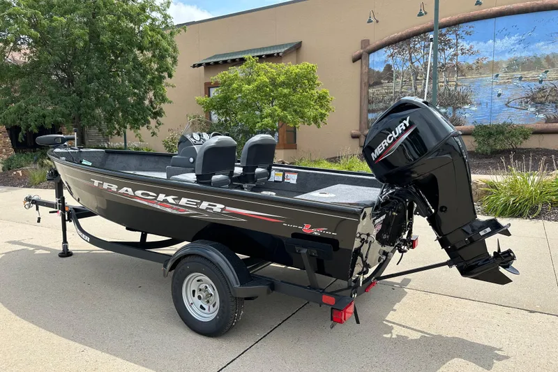 Slide: The Image of 2026 Tracker Super Guide V-16 SC boat with Mercury engine on trailer. - 2