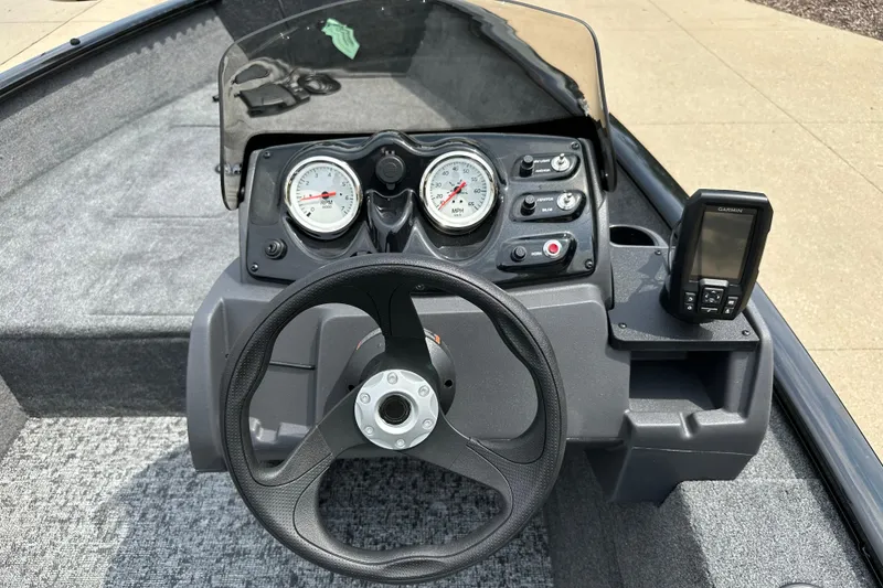 Slide: The Image of 2026 Tracker Super Guide V-16 SC boat dashboard with steering wheel and gauges. - 4