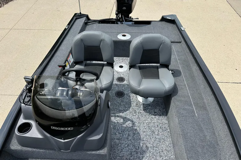 Slide: The Image of 2026 Tracker Super Guide V-16 SC boat interior with dual gray seats and steering console. - 5