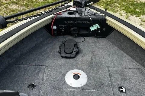 Slide: The Image of 2026 Tracker Targa V-18 WT boat interior with carpeted deck and fishing equipment. - 85