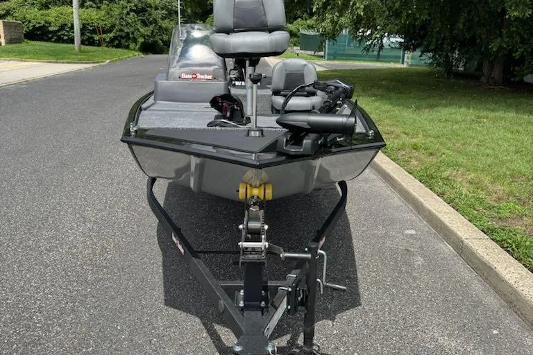 Slide: The Image of 2026 Tracker Bass Tracker Classic XL boat on trailer, parked on a suburban street. - 4