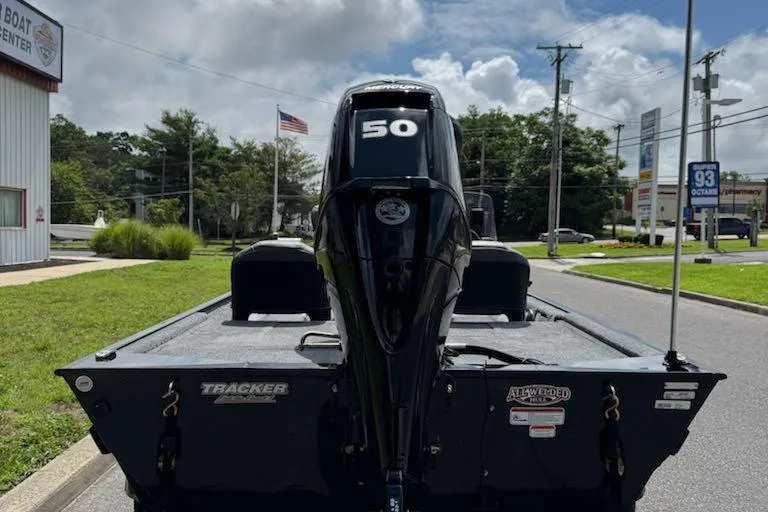Slide: The Image of 2026 Tracker Bass Tracker Classic XL boat with 50 HP engine, parked outdoors. - 5