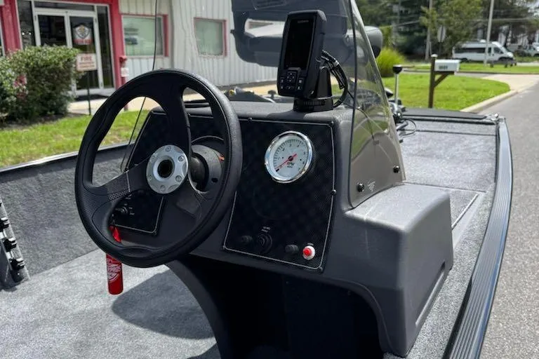 Slide: The Image of 2026 Tracker Bass Tracker Classic XL boat dashboard with steering wheel and gauge. - 6