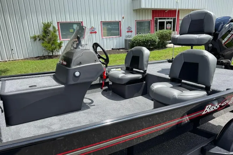 Slide: The Image of 2026 Tracker Bass Tracker Classic XL boat interior with seating and steering console. - 7