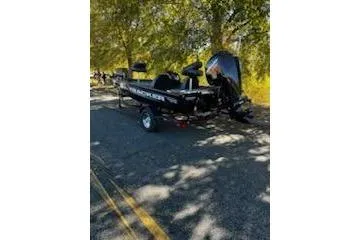 Slide: The Image of 2026 Tracker Pro Team 175 boat parked on a shaded road. - 2