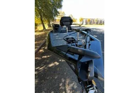 Slide: The Image of 2026 Tracker Pro Team 175 boat with fishing equipment, parked outdoors. - 6