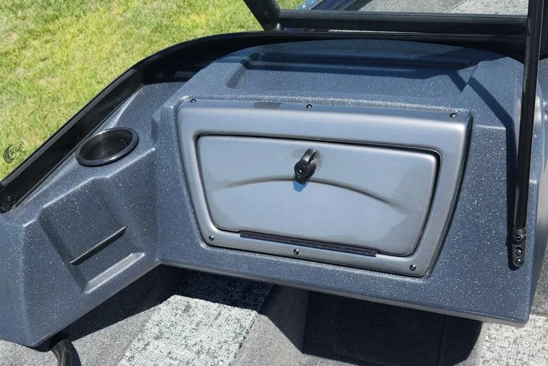 Slide: The Image of 2026 Tracker Pro Guide V-16 WT boat dashboard with storage compartment and cup holder. - 2