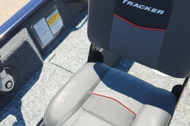 Slide: The Image of 2026 Tracker Pro Guide V-16 WT boat seat with gray upholstery and red accents. - 4