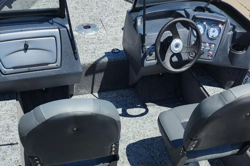 Slide: The Image of 2026 Tracker Pro Guide V-16 WT boat interior with steering wheel and seating. - 6