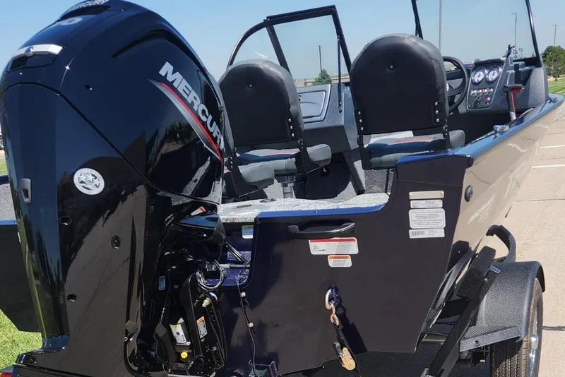 Slide: The Image of 2026 Tracker Pro Guide V-16 WT boat with Mercury engine, parked outdoors. - 8