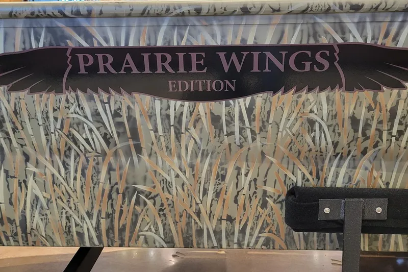 Slide: The Image of 2026 Tracker Grizzly 1650 T Prairie Wings Edition with camouflage design and logo. - 2