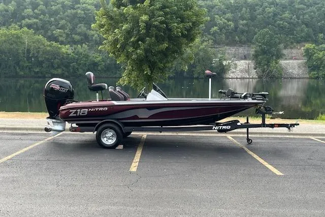 The Image of 2026 Nitro Z18 Pro boat on trailer by a scenic lake. - 0
