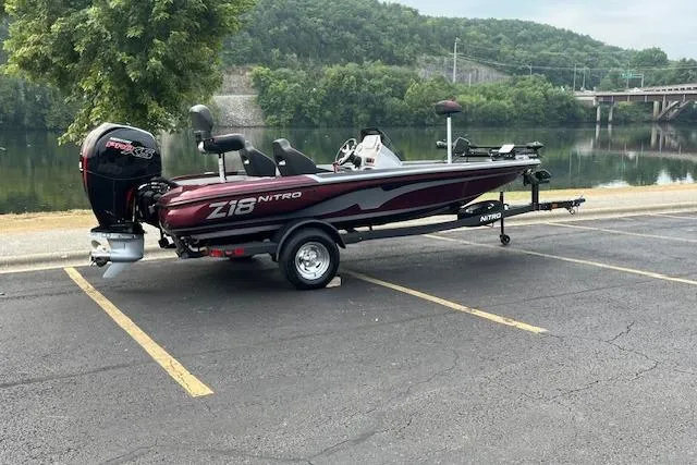 Slide: The Image of 2026 Nitro Z18 Pro boat on trailer by a lake, showcasing sleek design and modern features. - 1
