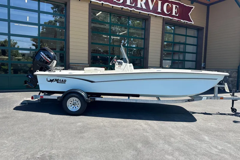 The Image of 2026 Mako Pro Skiff 17 CC boat on trailer outside service center. - 0