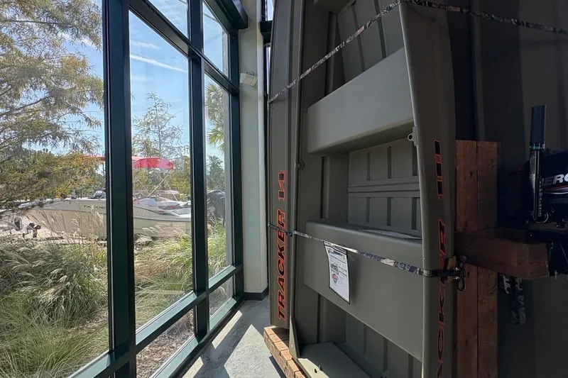 The Image of 2026 Tracker Grizzly 10 Jon boat displayed indoors near large windows. - 0